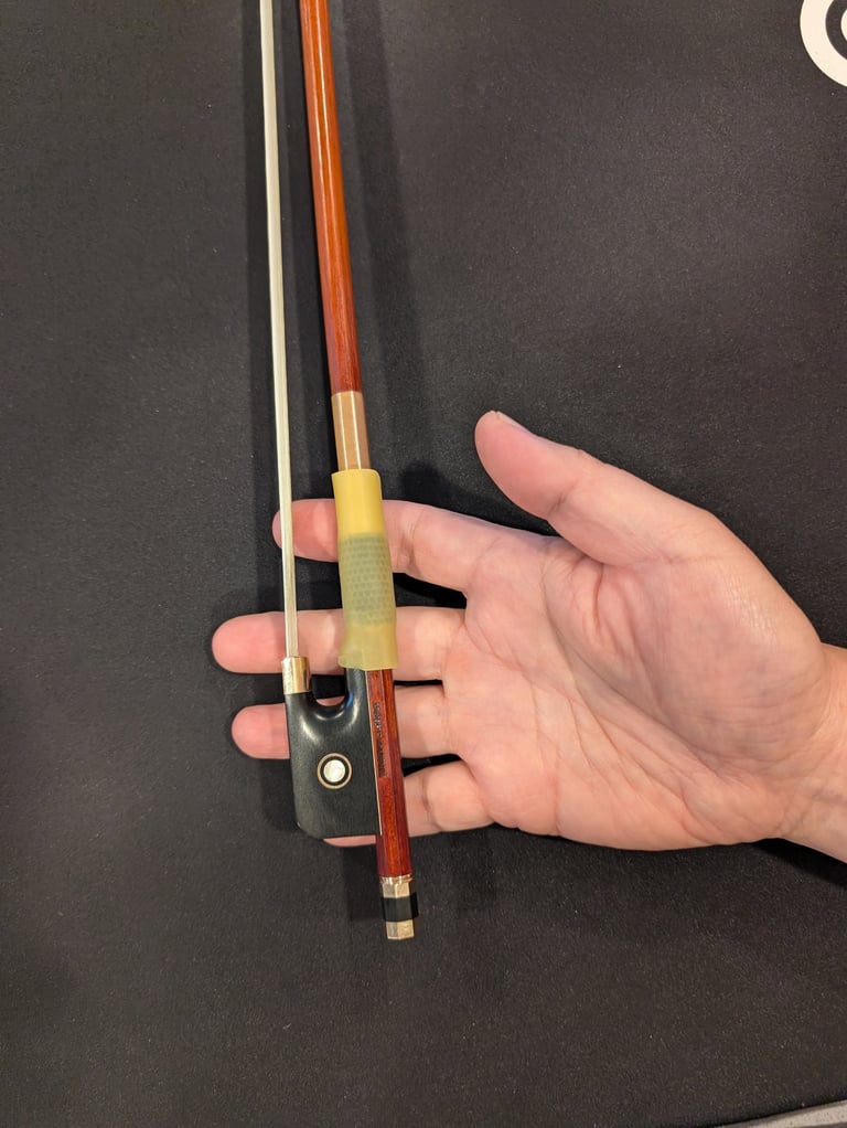 place the bow in the right hand