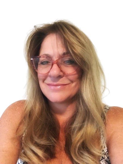 Smiling woman with long blonde hair wearing stylish pink glasses and a floral top.