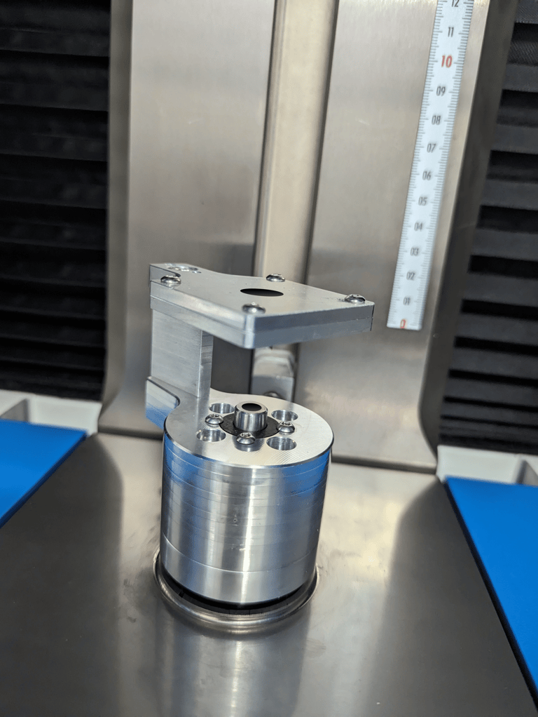 Aluminium metrology fixture for holding shaft component on optical shaft scanner.