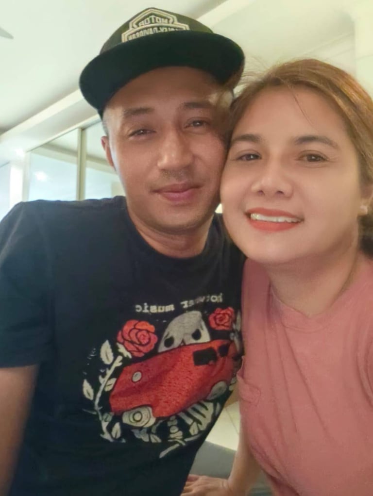 couple looking at camera cheek to cheek