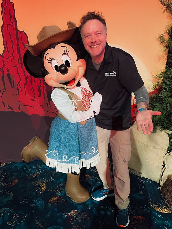 Minnie's Travel Boutique co-owner Chris Breedlove pictured with Minnie Mouse at The Disneyland® Hotel.