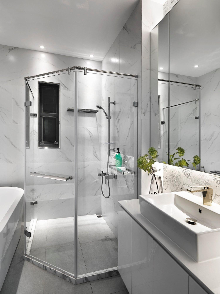 Modern bathroom with glass shower and white vanity – shows the tidy result after a leak repair in an