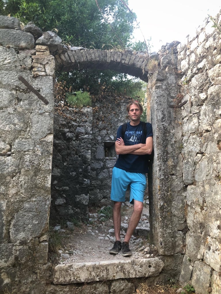 Spiritual investigator and exorcist standing inside ancient ruins during years of paranormal study