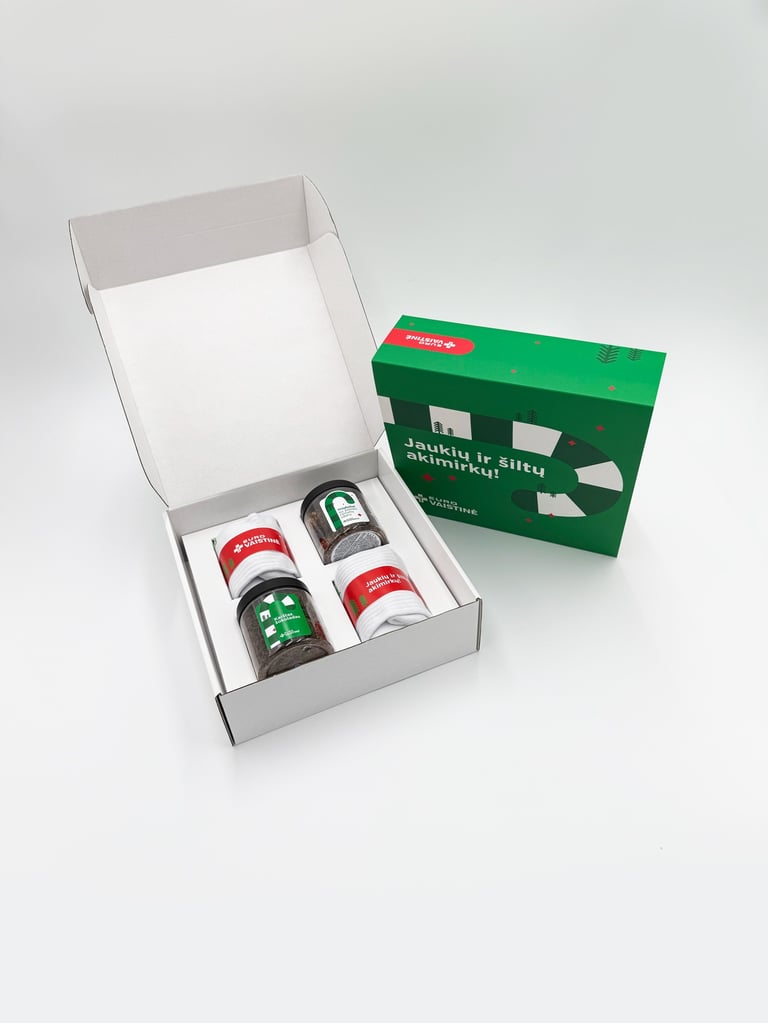 Eurovaistine Christmas gift box with tea and white socks on a white background.