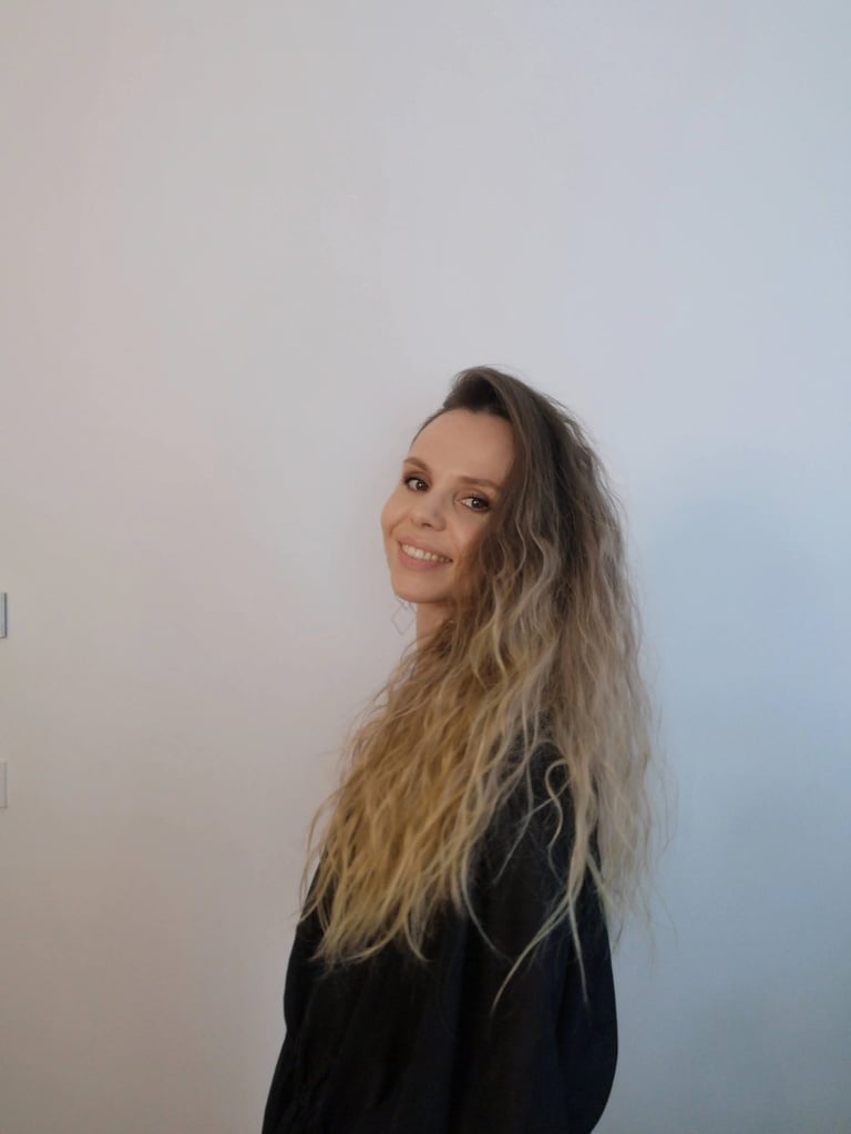 Christine Hauser, certified RTT Practitioner, smiling in a relaxed portrait against light background