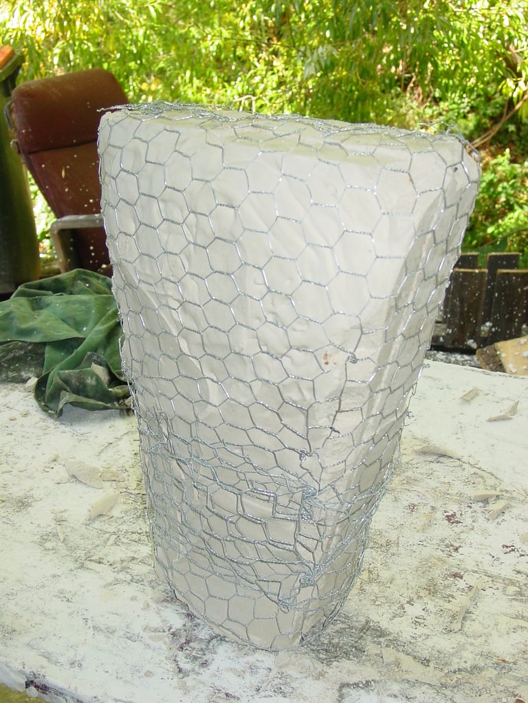 the mould covered in chicken wire to maintain it's shape in the heat of the kiln