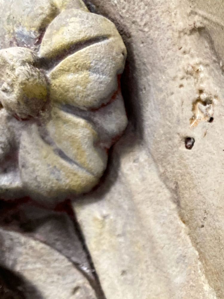 Extreme detail shot of a Victorian flower ornament painted to look like sandstone.
