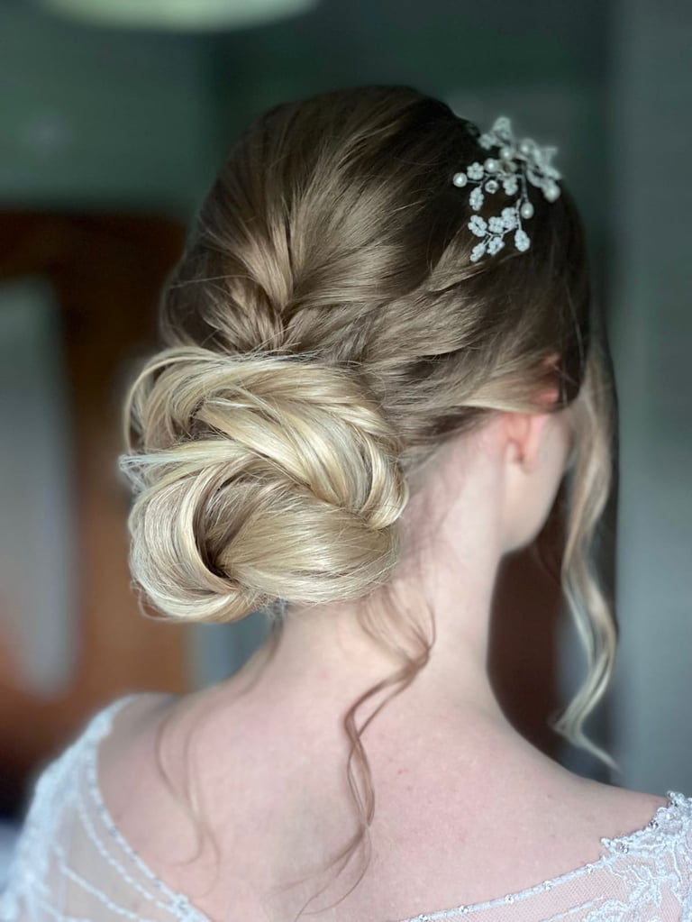 a woman with wedding hair with a flower in her hair