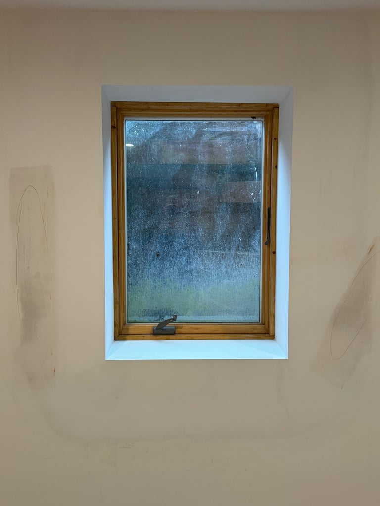 repaired drywall around window in residential basement