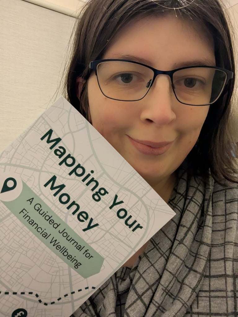 Bex holding the Mapping Your Money guided journal.