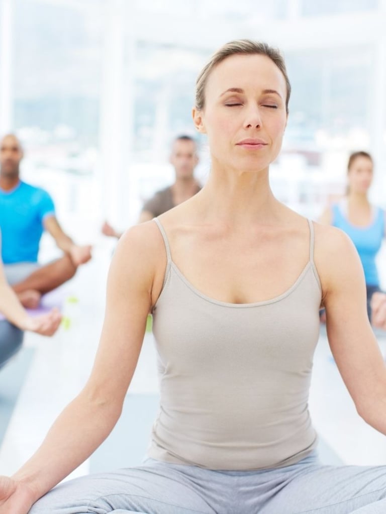 a woman sitting in a yoga pose