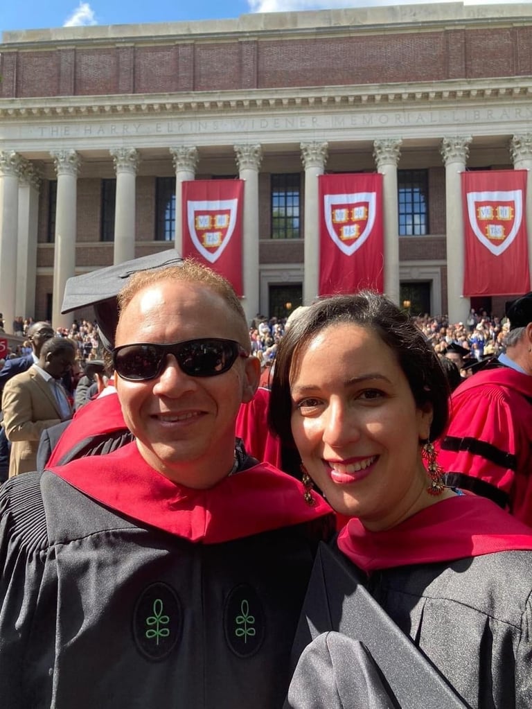 a man and woman in graduation gowns and caps