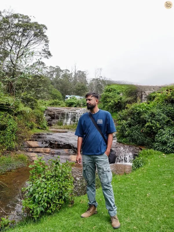 Traveler posing at Liril Falls in Kodaikanal.