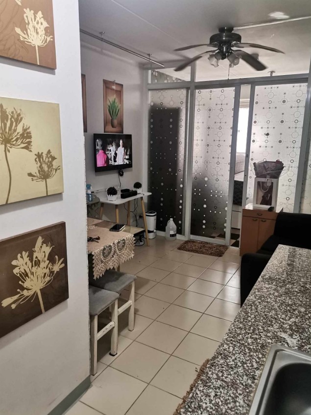 a kitchen with a television and a television