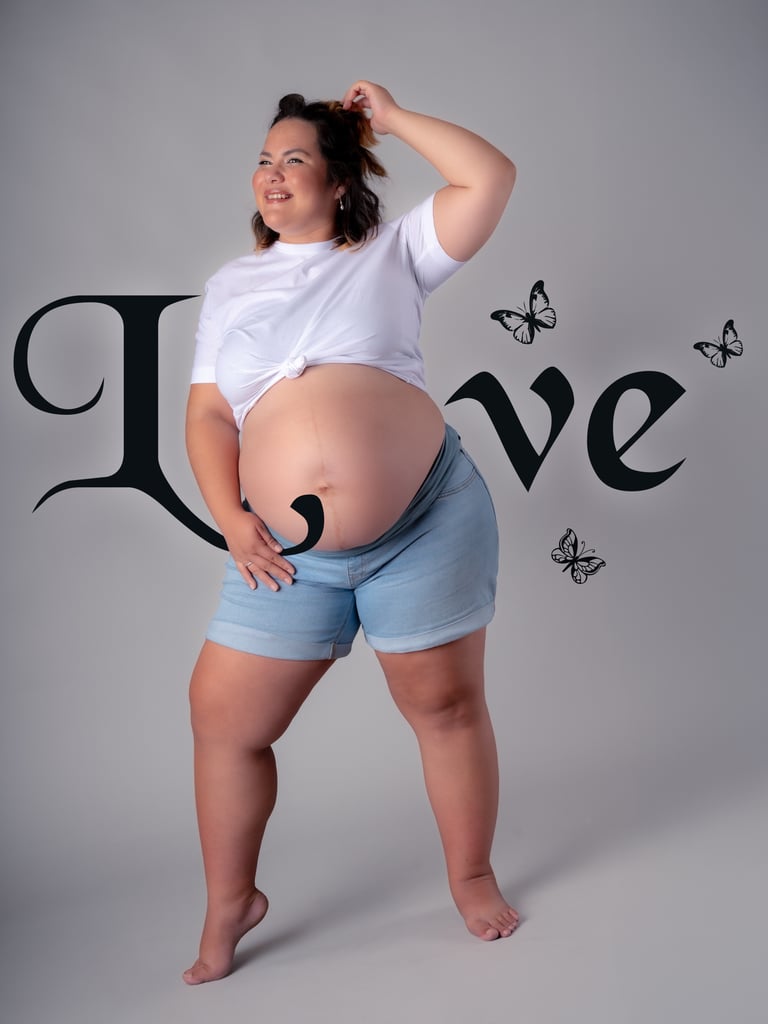 a pregnant woman in a white shirt and shorts
