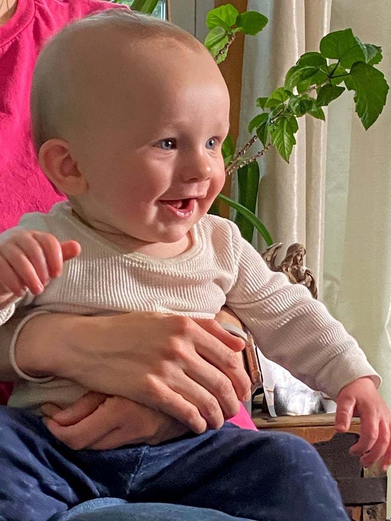 a nine month old smiling baby