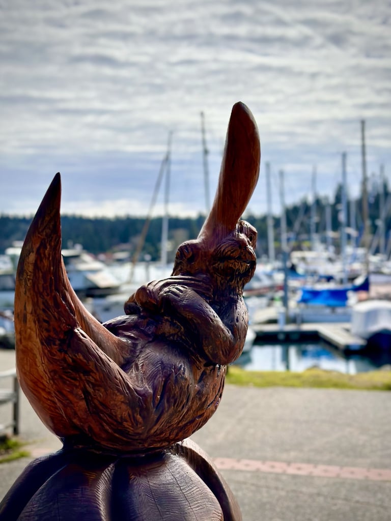 a wooden sculpture of an otter on a wooden moon