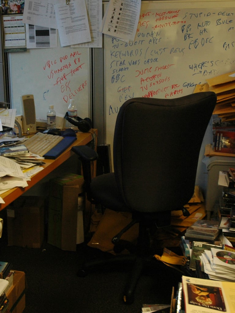 a desk with a computer monitor and a laptop