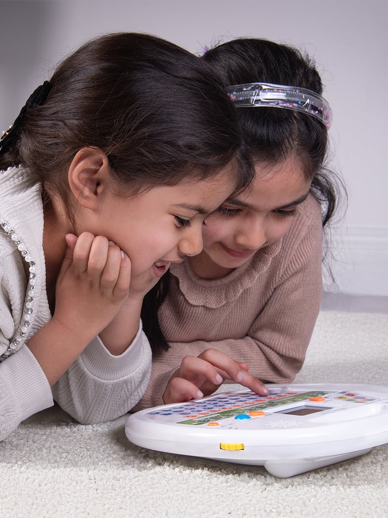 2 girls using the Quran reader by Desi Doll