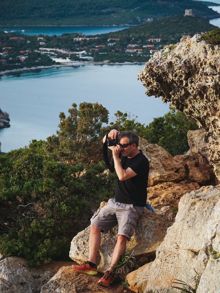 Franco Prisco photographing the landscape from Capo Caccia promontory, Sardinia.