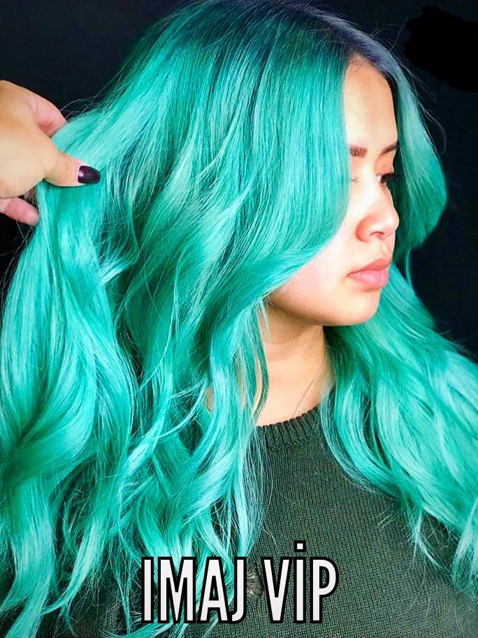 a woman with green hair and blue hair with the words imaa vip