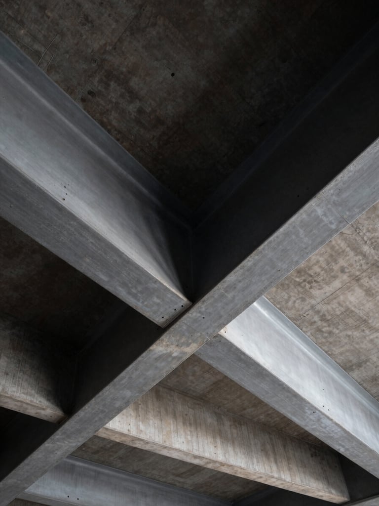 High-contrast architectural close-up of structural steel beams intersecting with reinforced concrete, dramatic shadows, cold steel gray tones