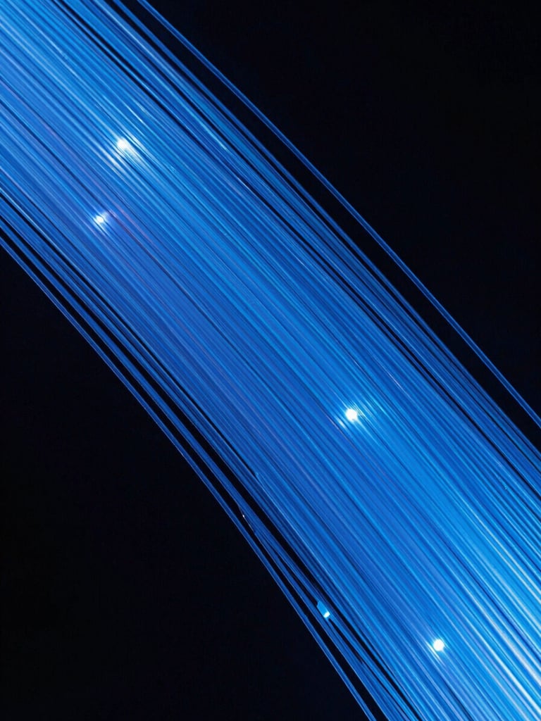 Macro shot of glowing blue fiber optic strands against a dark background, sharp focus, high contrast studio lighting with cool daylight accents.