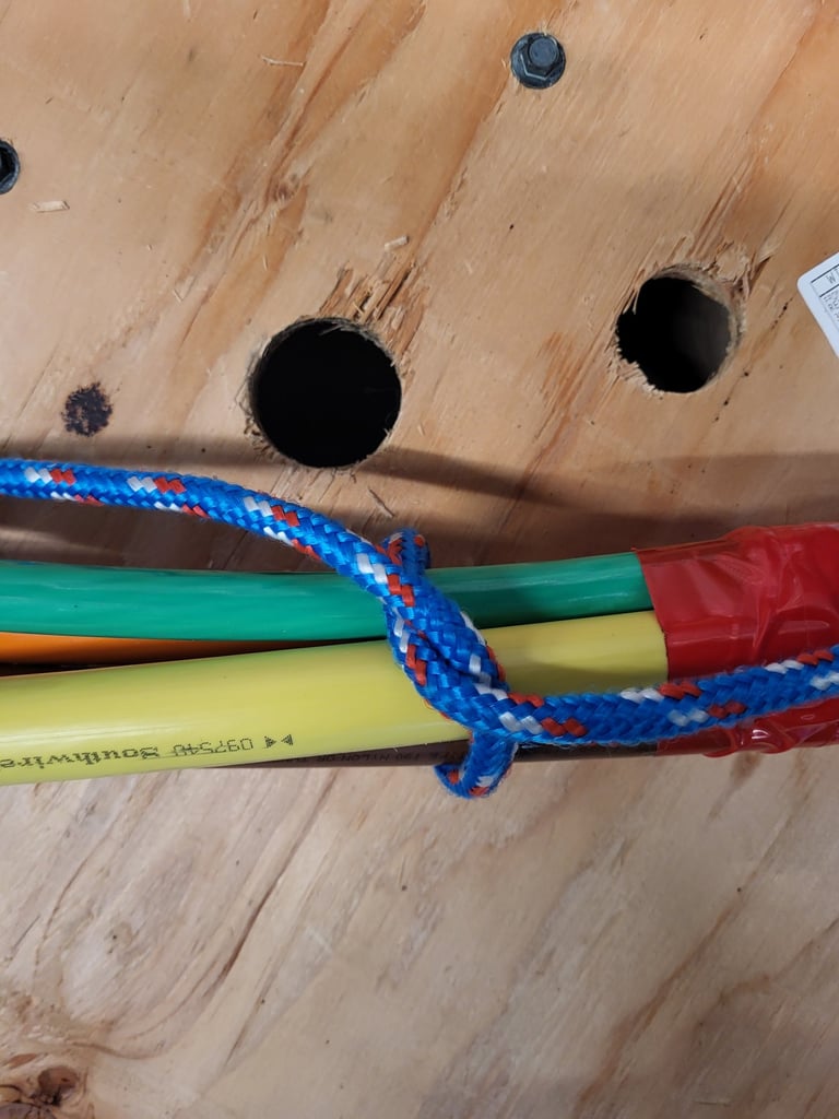 Close-up of multiple colored electrical conductors bundled together for a wire pull.