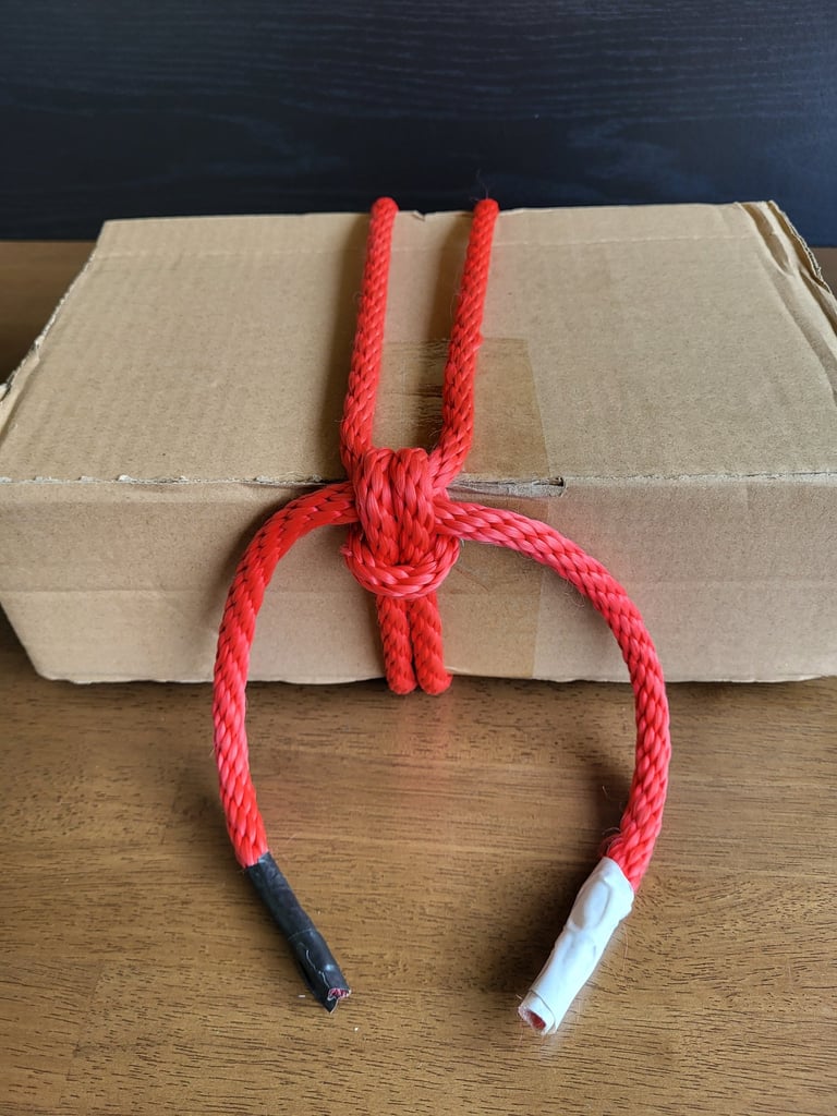 Woodlands-ziptie-knot cinched tight on a cardboard box