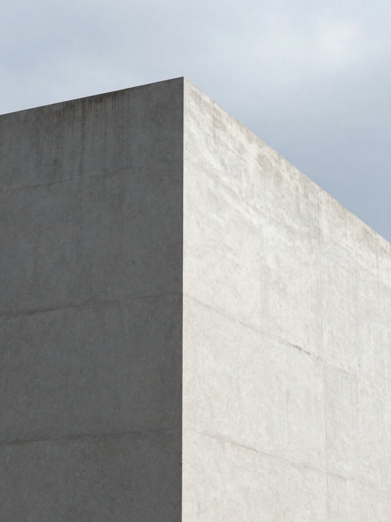 A minimalist close-up of a sharp architectural concrete corner with clean shadows under overcast daylight, modern corporate aesthetic.