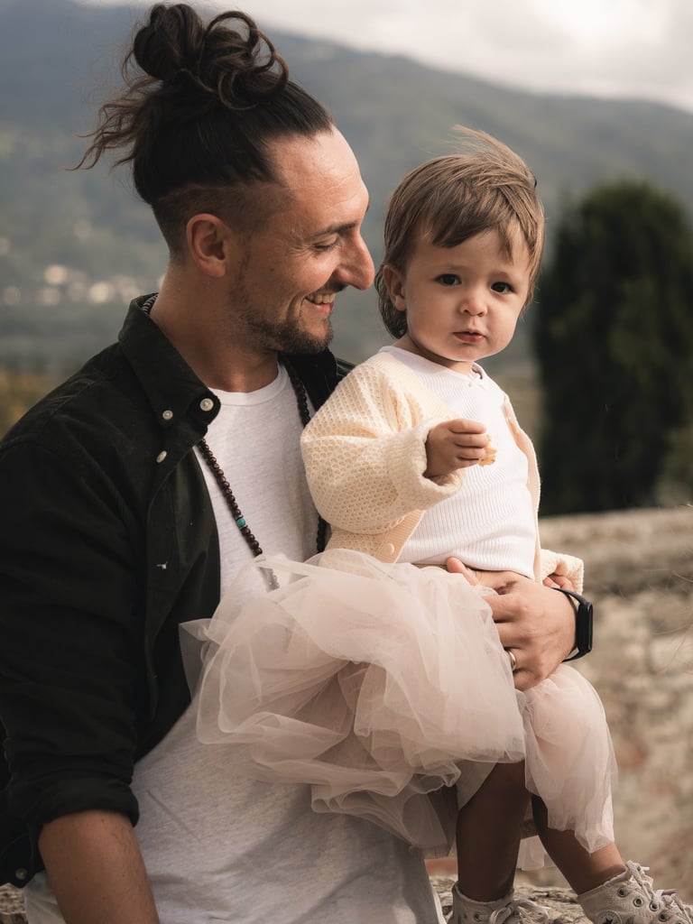 a man with a child on his lap, holding a baby