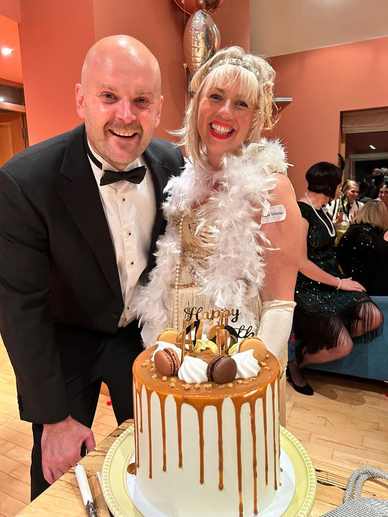 man and woman smiling at murder mystery birthday party