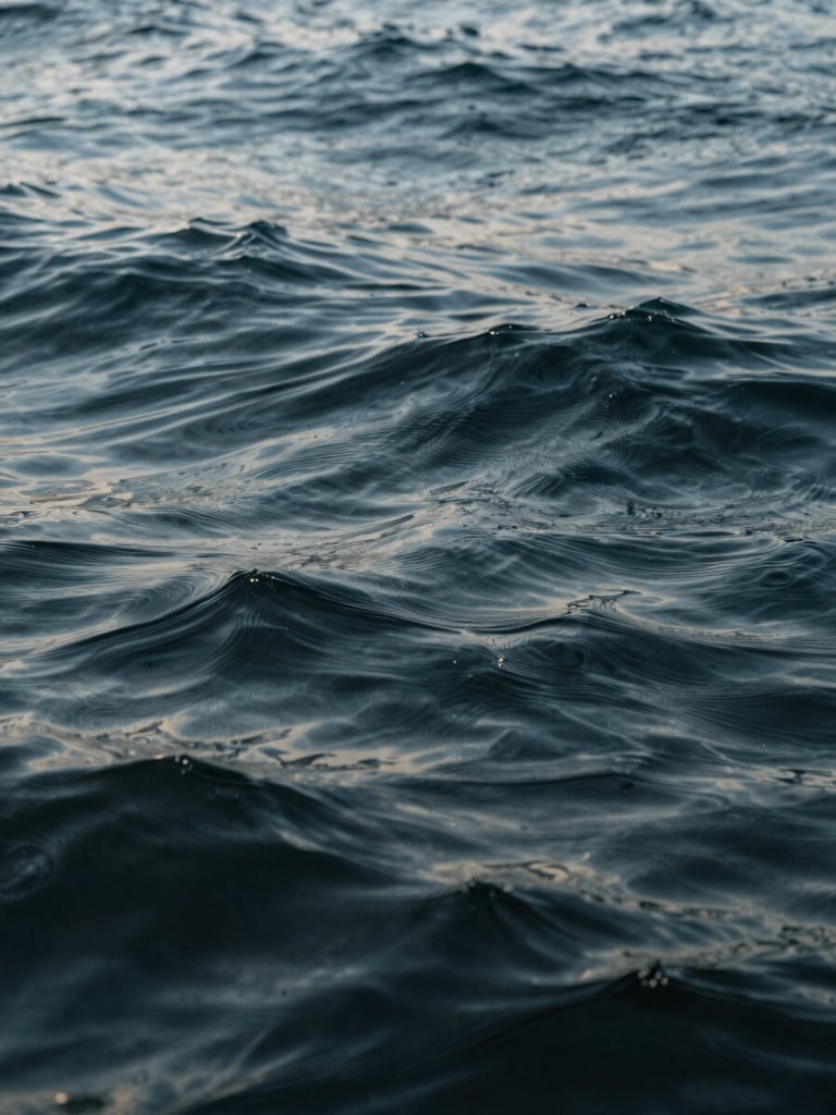Abstract close-up texture of deep ocean water with gentle ripples, soft natural lighting, editorial composition, calm luxury aesthetic