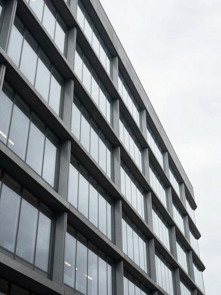Wide architectural detail of a contemporary office building facade, clean geometric glass and steel lines receding to the right, cool overcast daylight, no people, minimal and structural