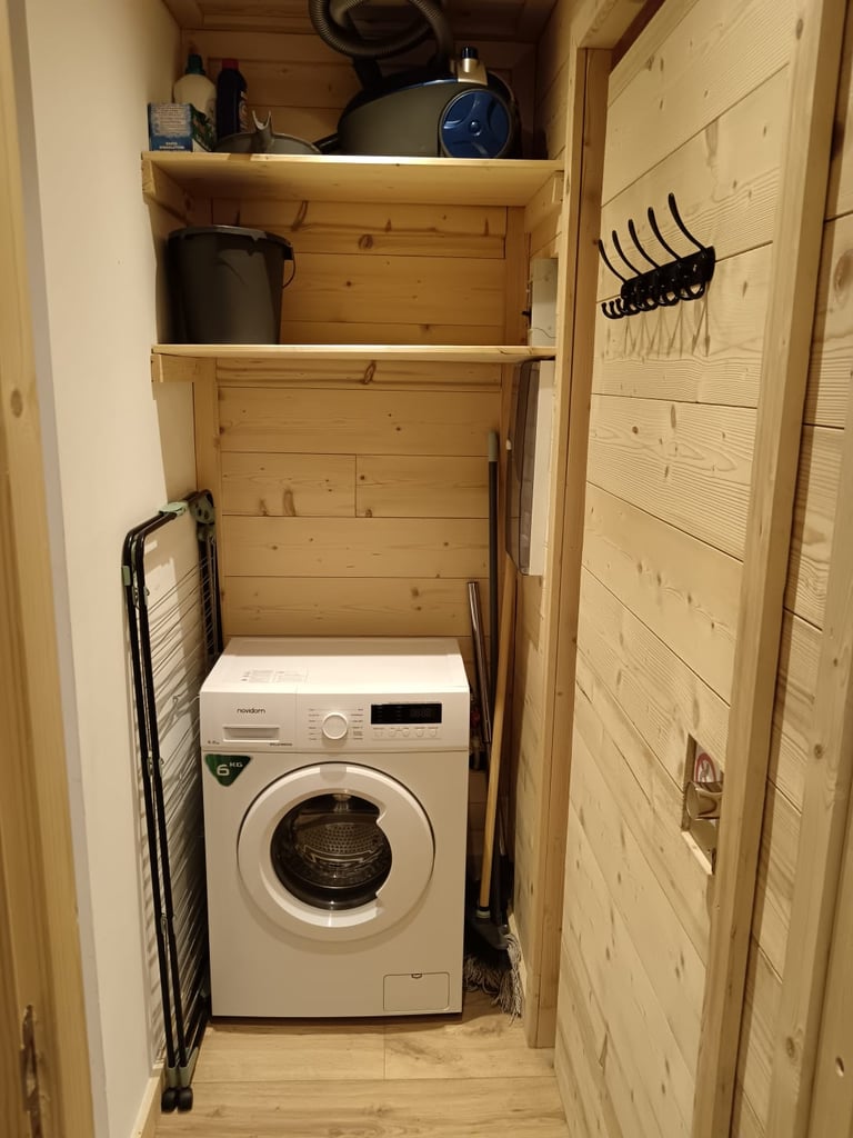 Built-in washing machine and alpine storage area in the StayValThorens apartment in Val Thorens