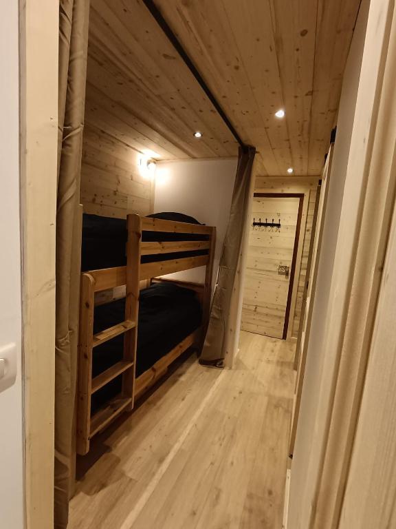 Mountain sleeping area with bunk beds and wooden interiors inside a practical Val Thorens ski-in ski-out apartment.