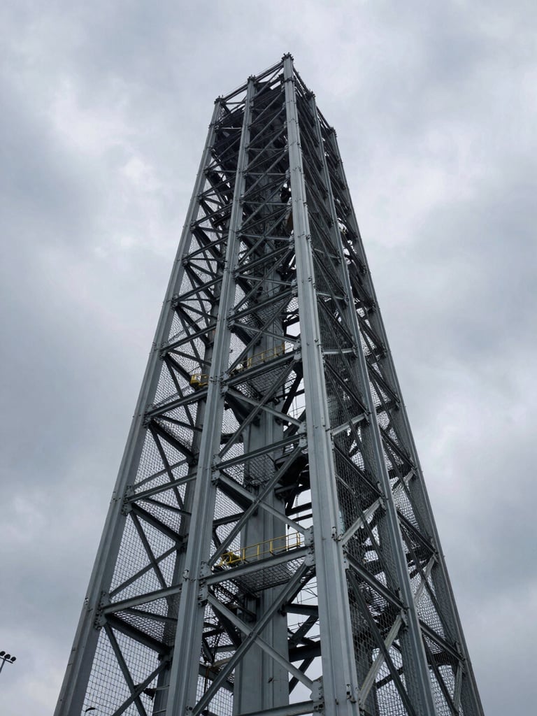 Low-angle perspective of a massive steel cage structure for a bridge pillar, dramatic overcast sky, raw industrial power.