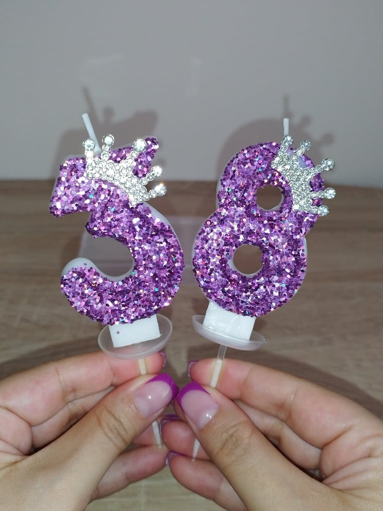 Purple glitter number birthday candle with crown and sequins, safe wax cake topper for parties.