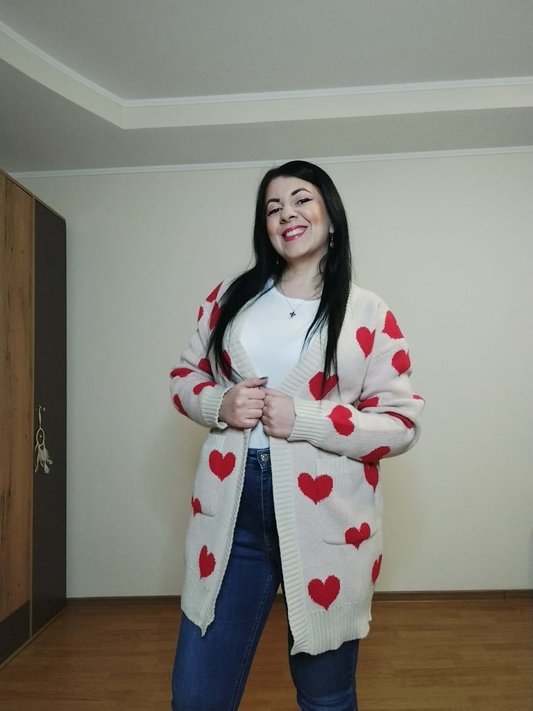 Woman wearing apricot heart print long cardigan sweater with pockets, ribbed knit open front 