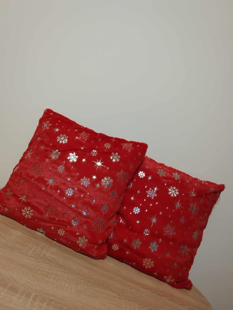 set of 2 red faux fur pillow covers with silver snowflake glitter pattern for Christmas home decor 