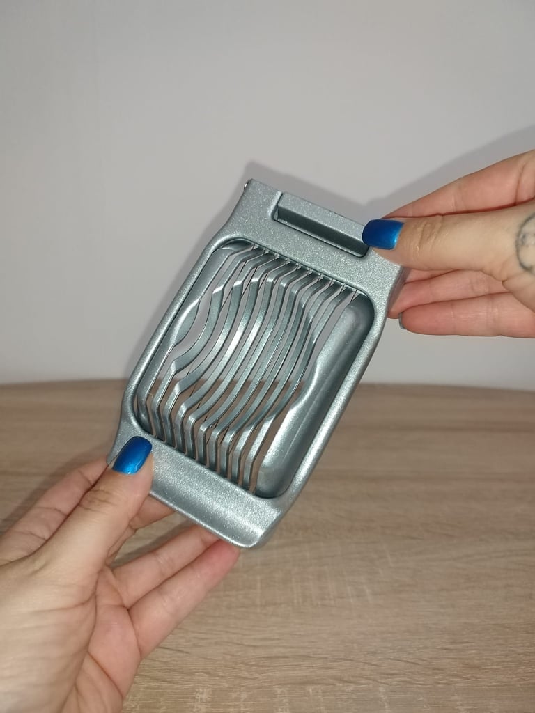Stainless steel wire egg slicer with aluminum base for slicing hard-boiled eggs, strawberries, etc