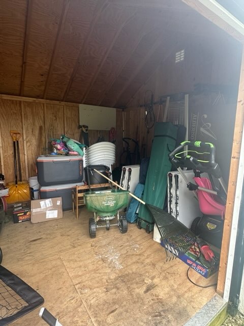 a cluttered shed with outdoor equipment