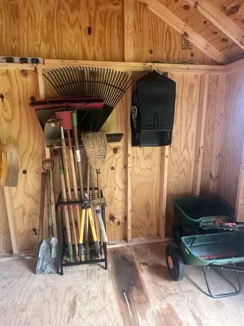 an organized shed with garden tools