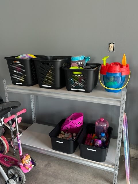 an organized shelving unit with labeled containers