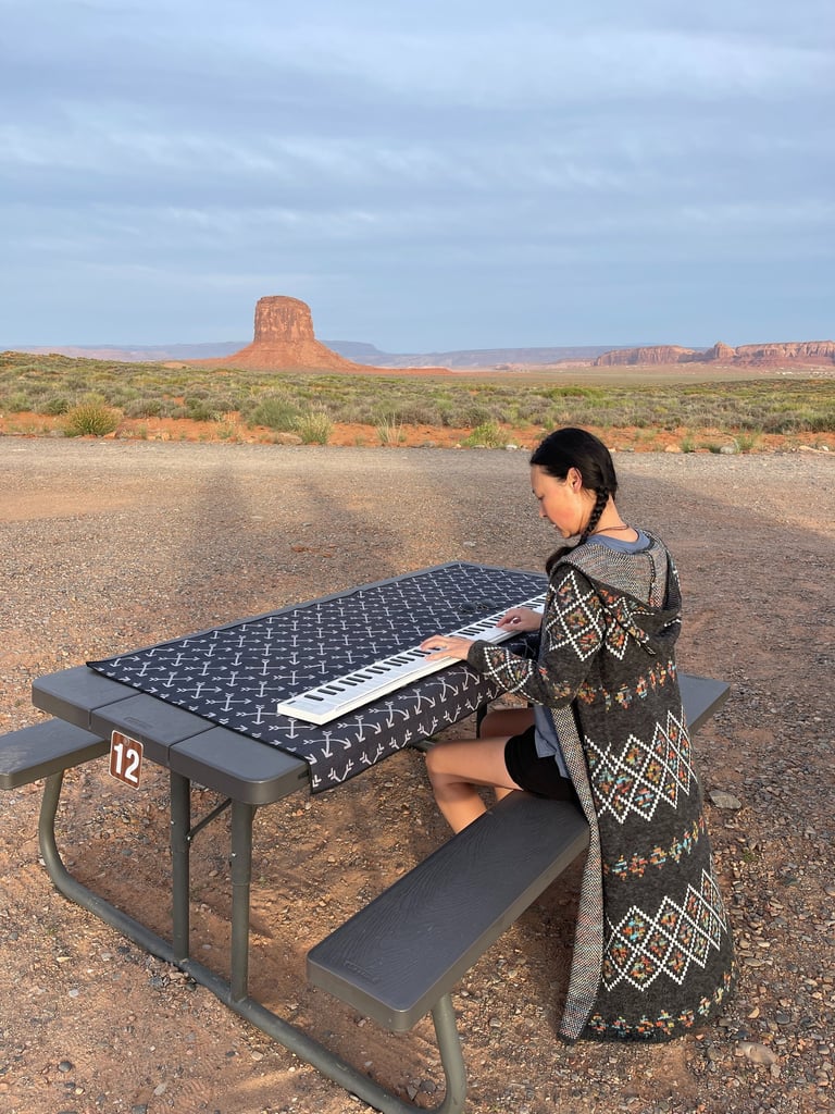 Composer Jen Smith Lanthier playing the keyboard outdoors in Monument Valley