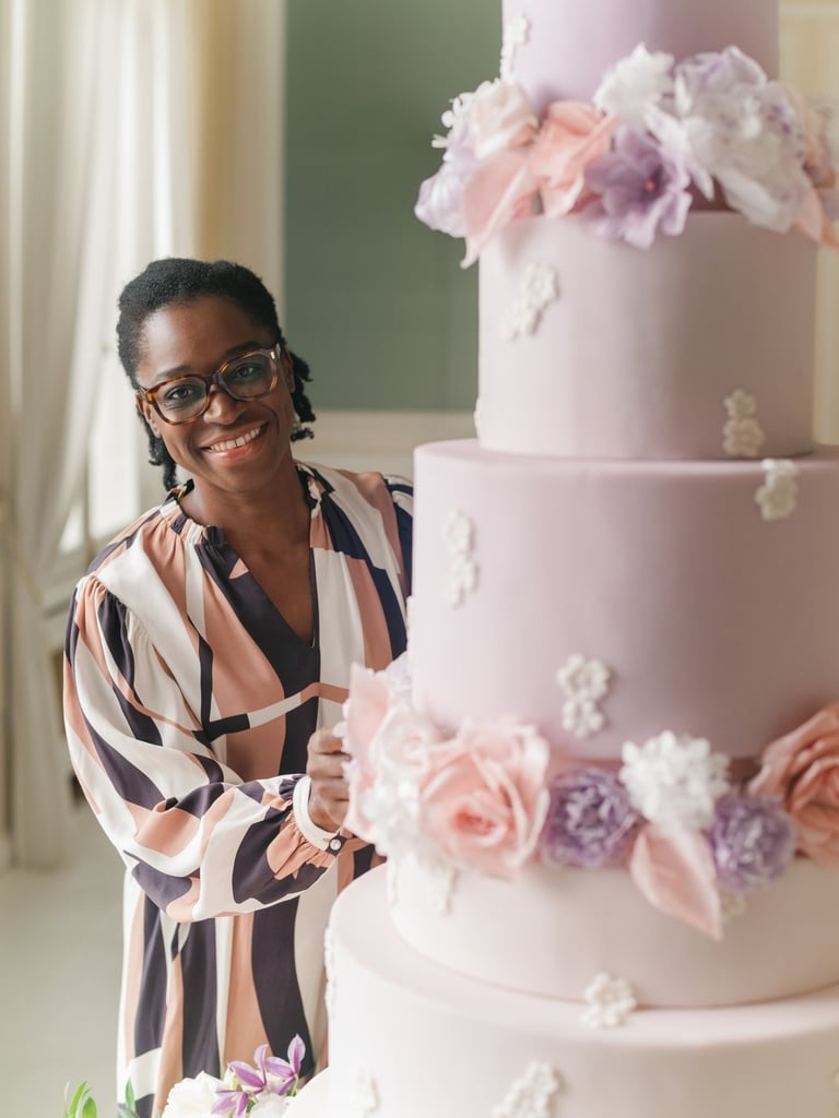 portrait of wedding cake designer with a luxury wedding cake at chateau de bouffemont near paris