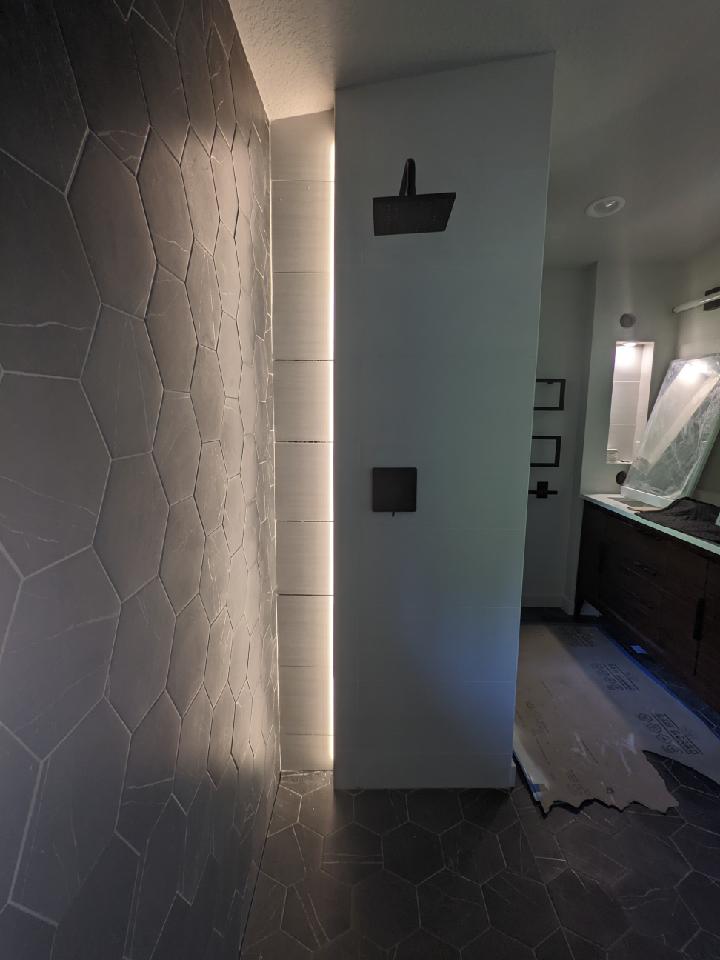 lighting in shower with glass shelves