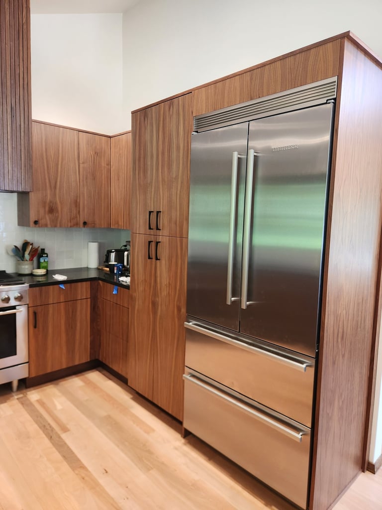stainless steel refrigerator and walnut cabinets