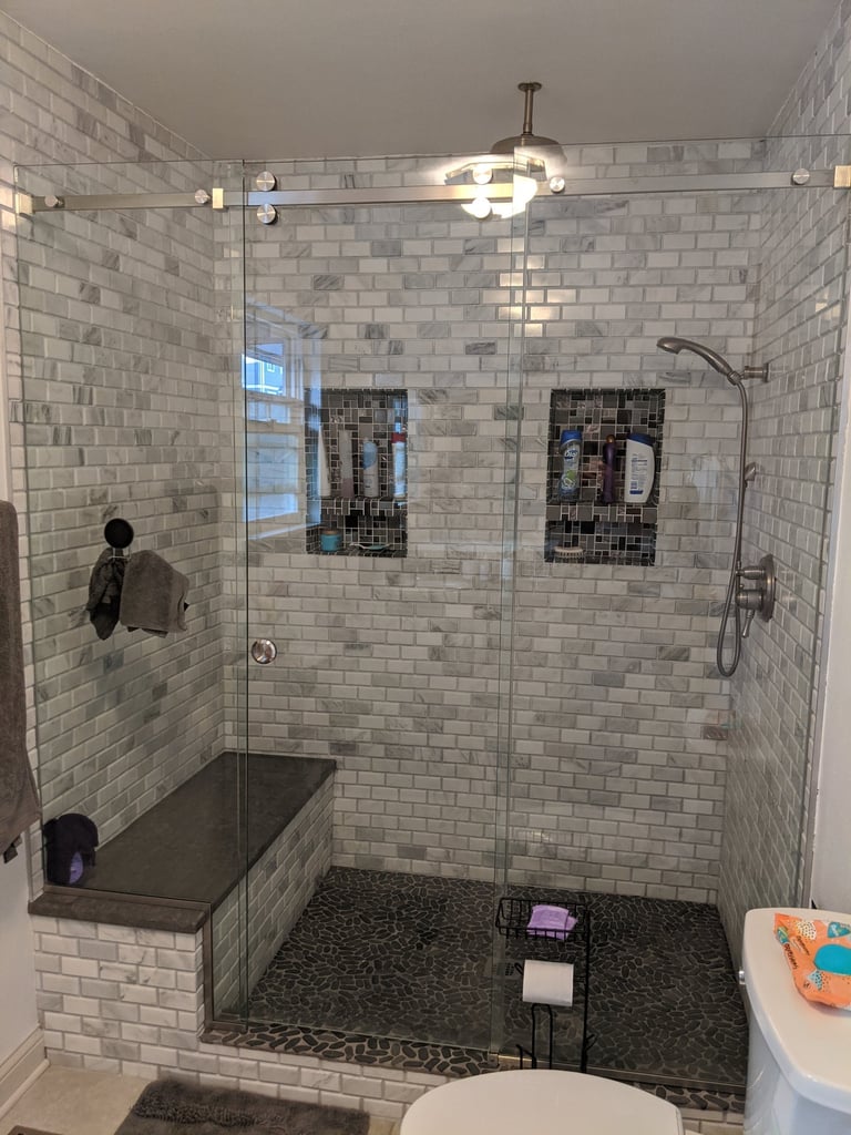 subway tile with 2 shampoo niches.