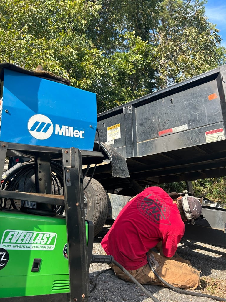 a man welding a heavy trailer